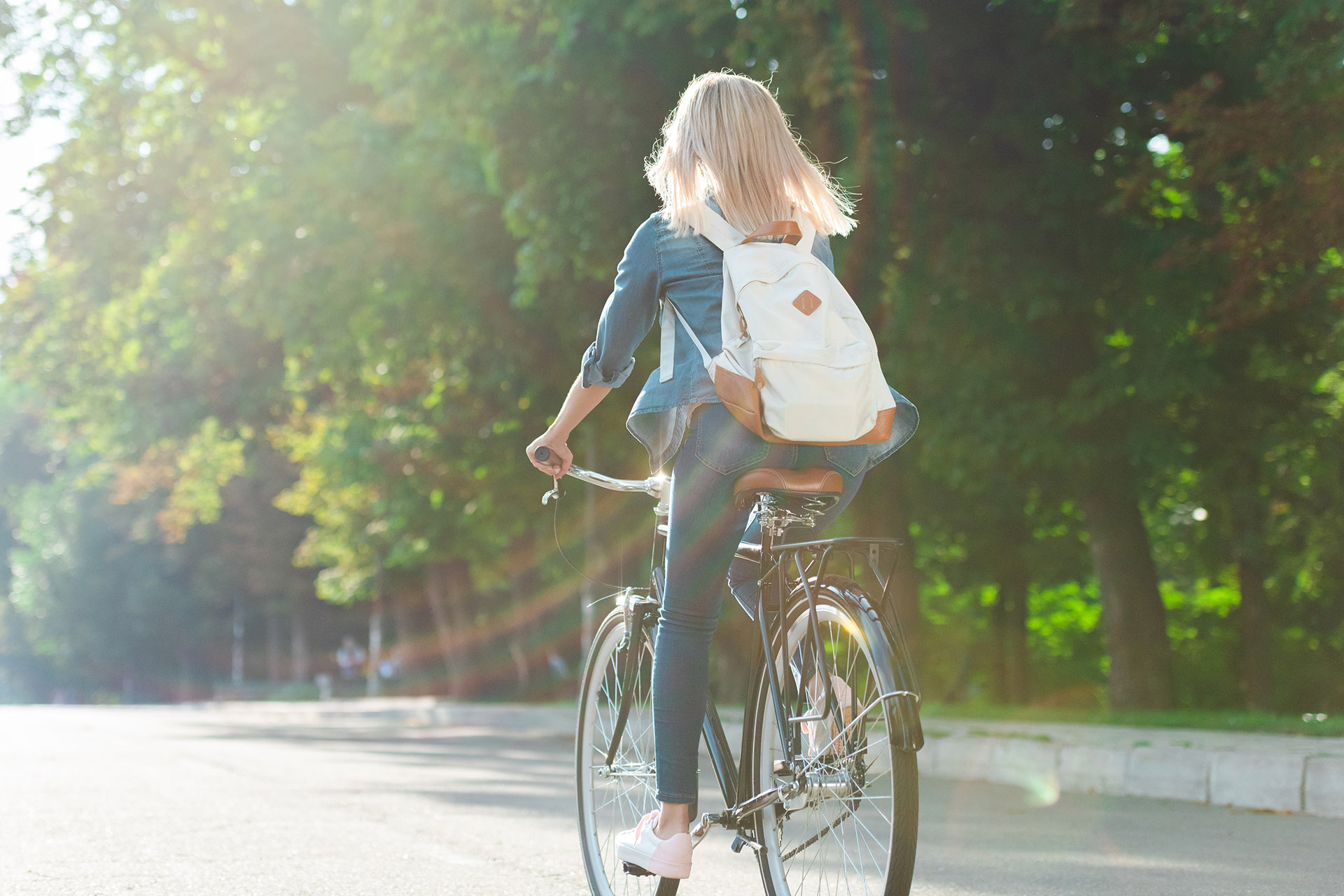 Girl Riding Bicycle on Roadway